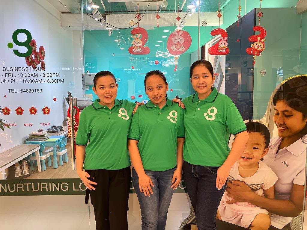 Green Employment helpers welcoming a family at the office