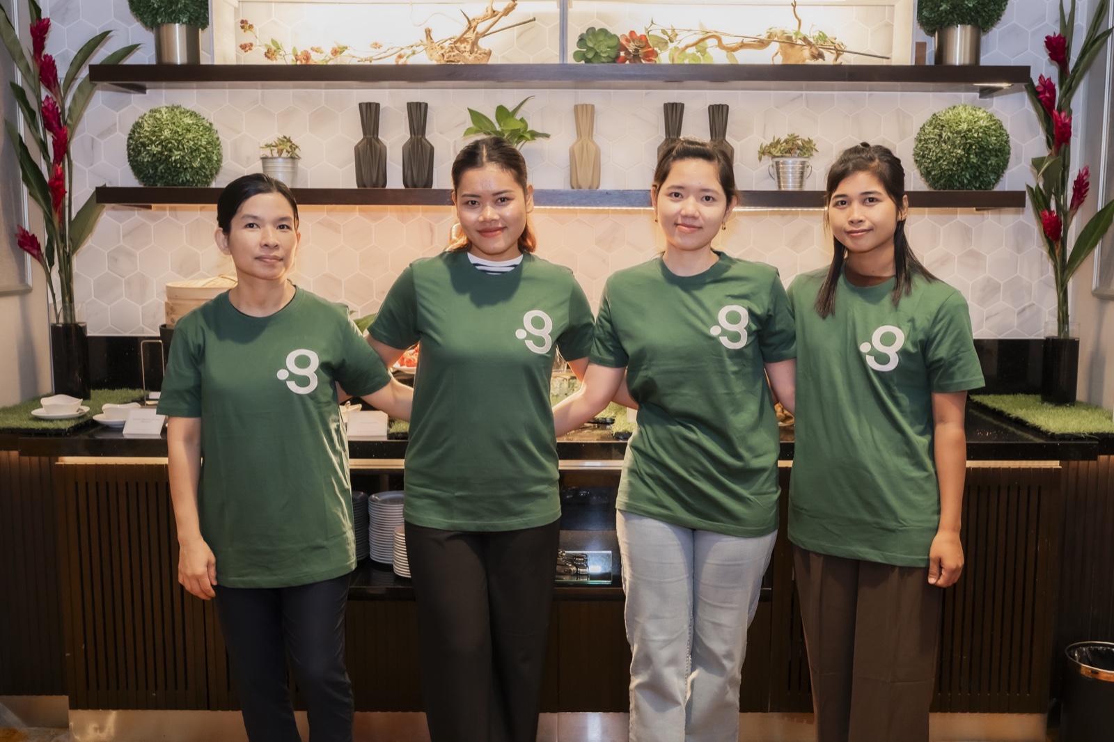 Domestic helpers placed through Green Employment, in the green uniform