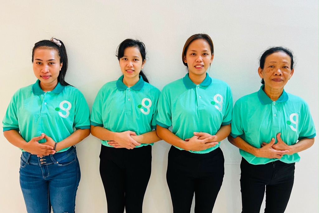 Domestic helpers placed through Green Employment, together in uniform